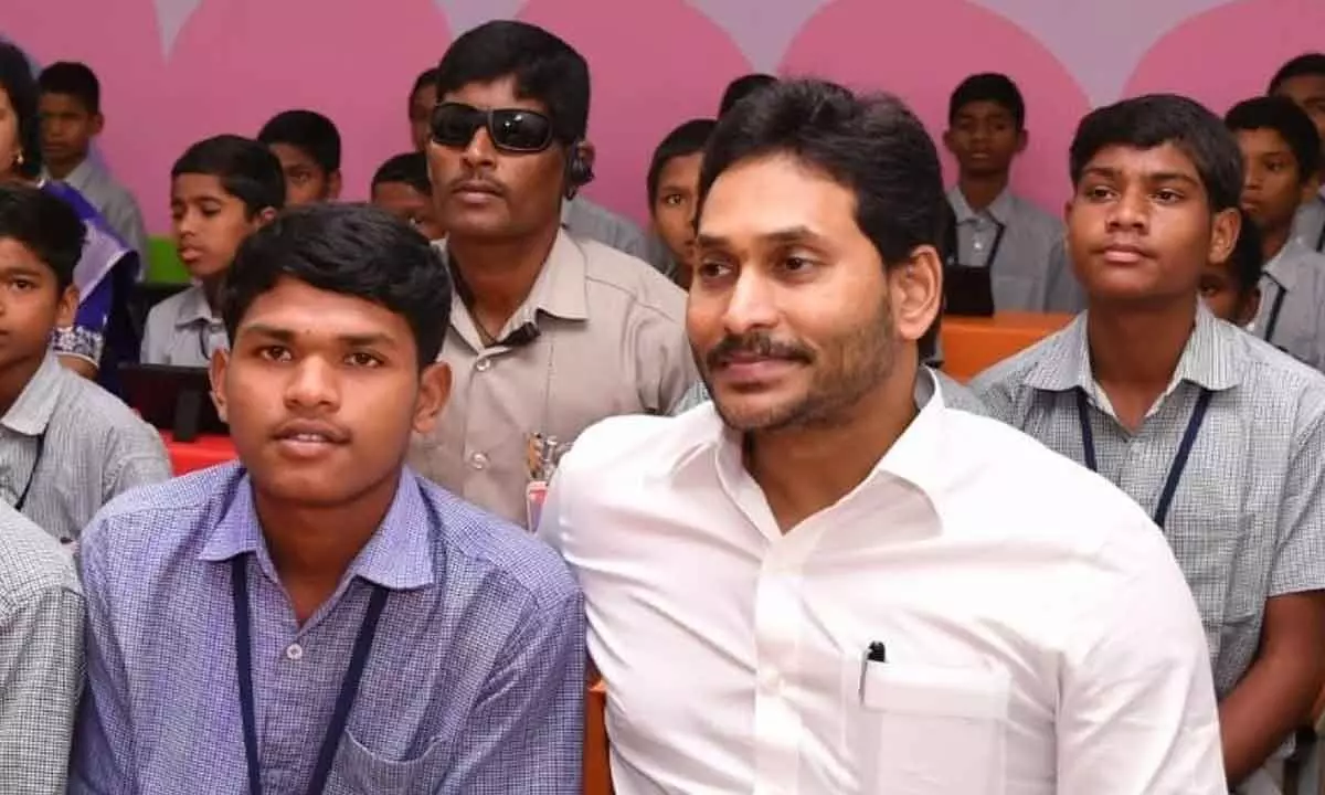 CM YS Jagan Mohan Reddy celebrates his birthday by spending time with tribal students at Chintapalli in ASR district on Thursday after distribution of tabs