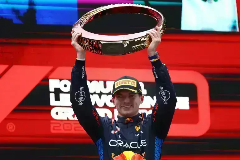 Red Bulls Max Verstappen celebrates with the trophy after winning the Chinese Grand Prix