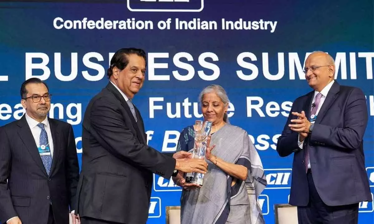 Union Finance Minister Nirmala Sitharaman presents CII President Award to NaBFID Chairman K V Kamath during the CII Annual Business Summit, in New Delhi on Friday