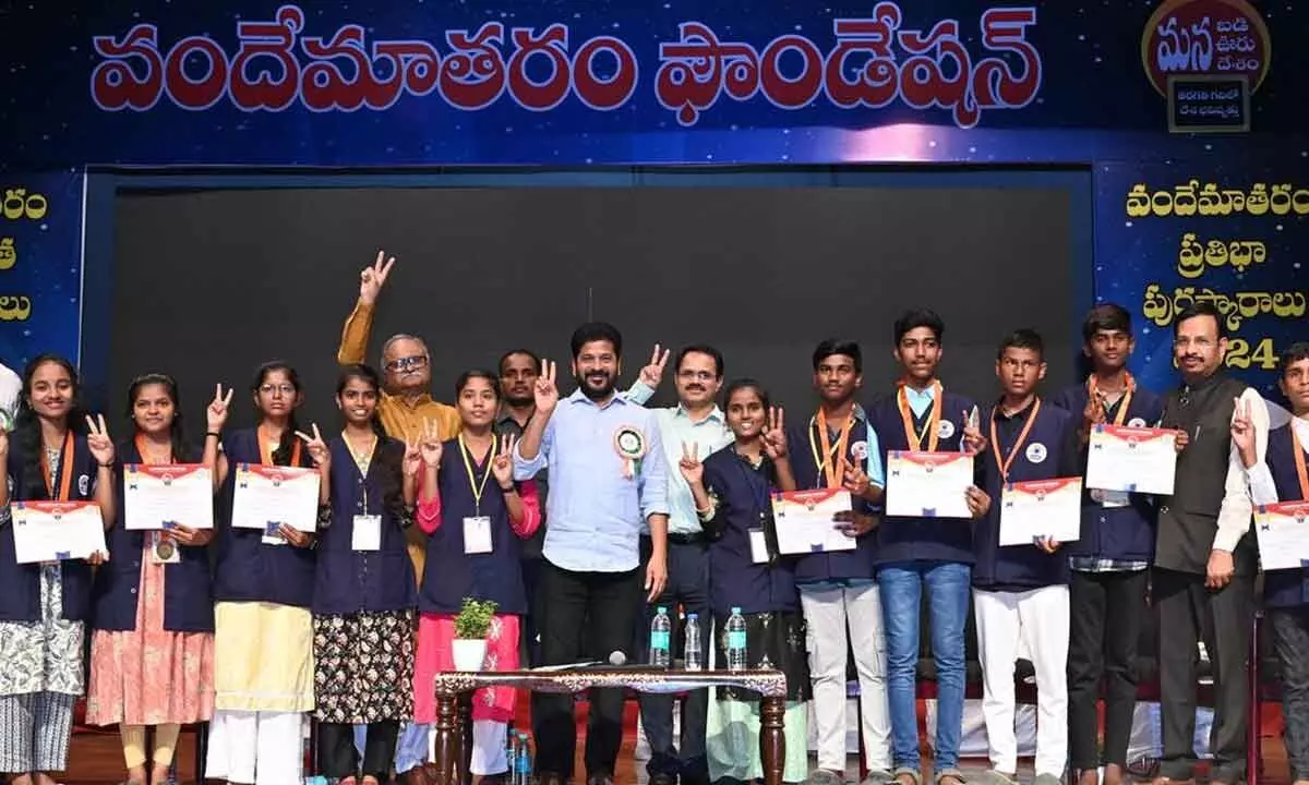 Telangana Chief Minister A Revanth Reddy with govt school students, after handing over the awards, in the city on Monday