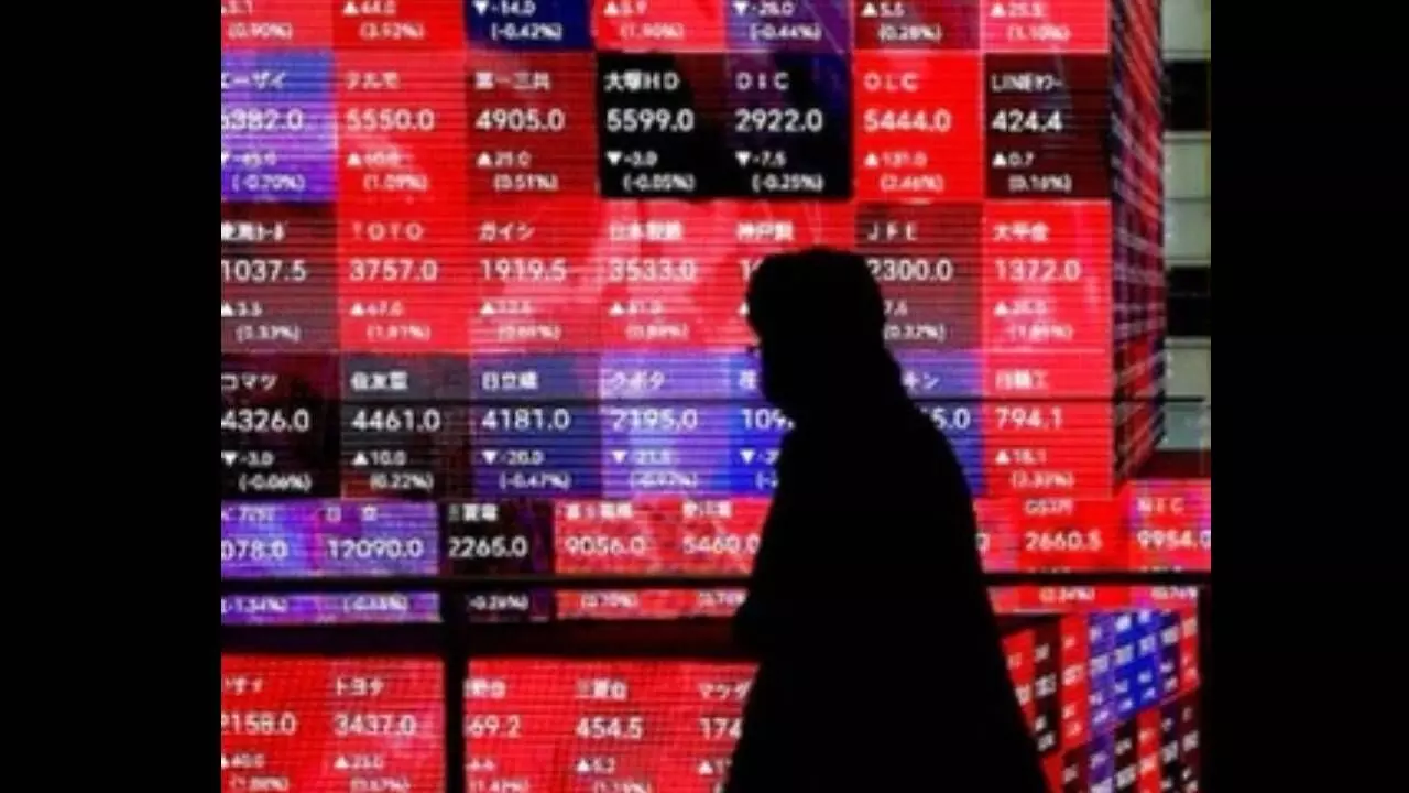 Tokyo stocks rise on Wall Street gains, weak yen